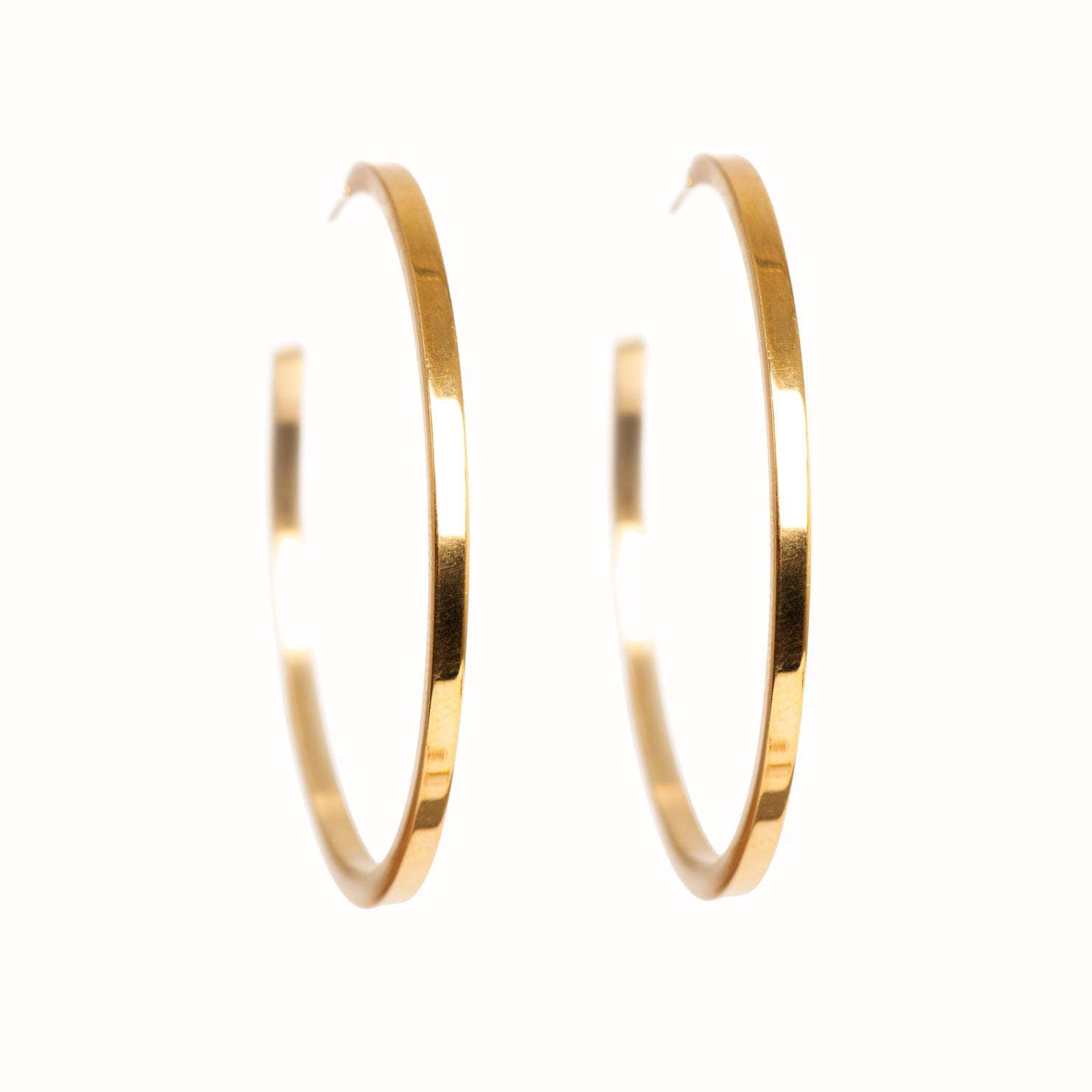 Gold hoop earrings on a white background