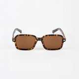 Sunglasses with tortoiseshell frame and brown lenses on a white background