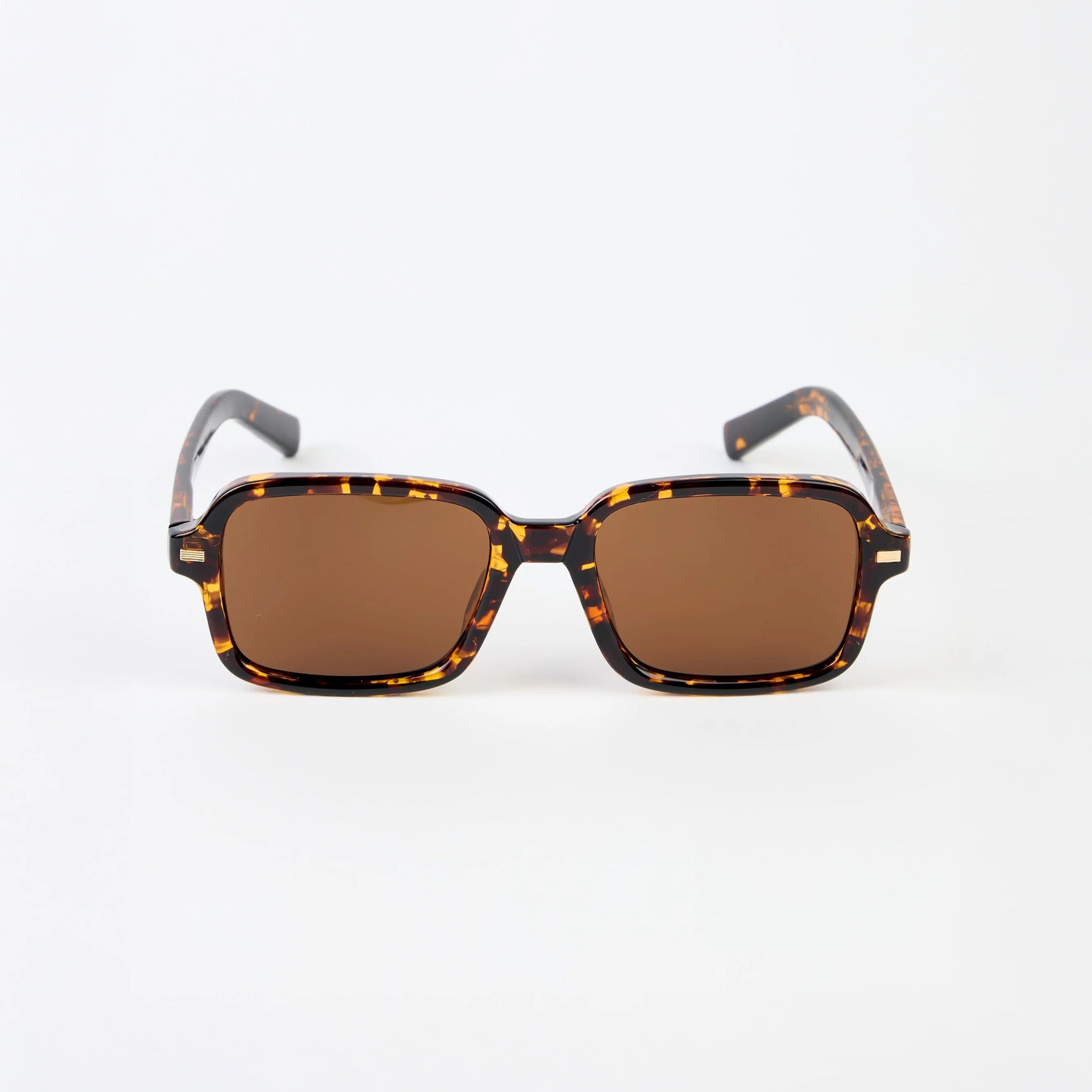 Sunglasses with tortoiseshell frame and brown lenses on a white background