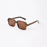 Sunglasses with tortoiseshell frame and brown lenses on a white background