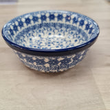 Ceramic bowl with blue and white pattern on a beige surface