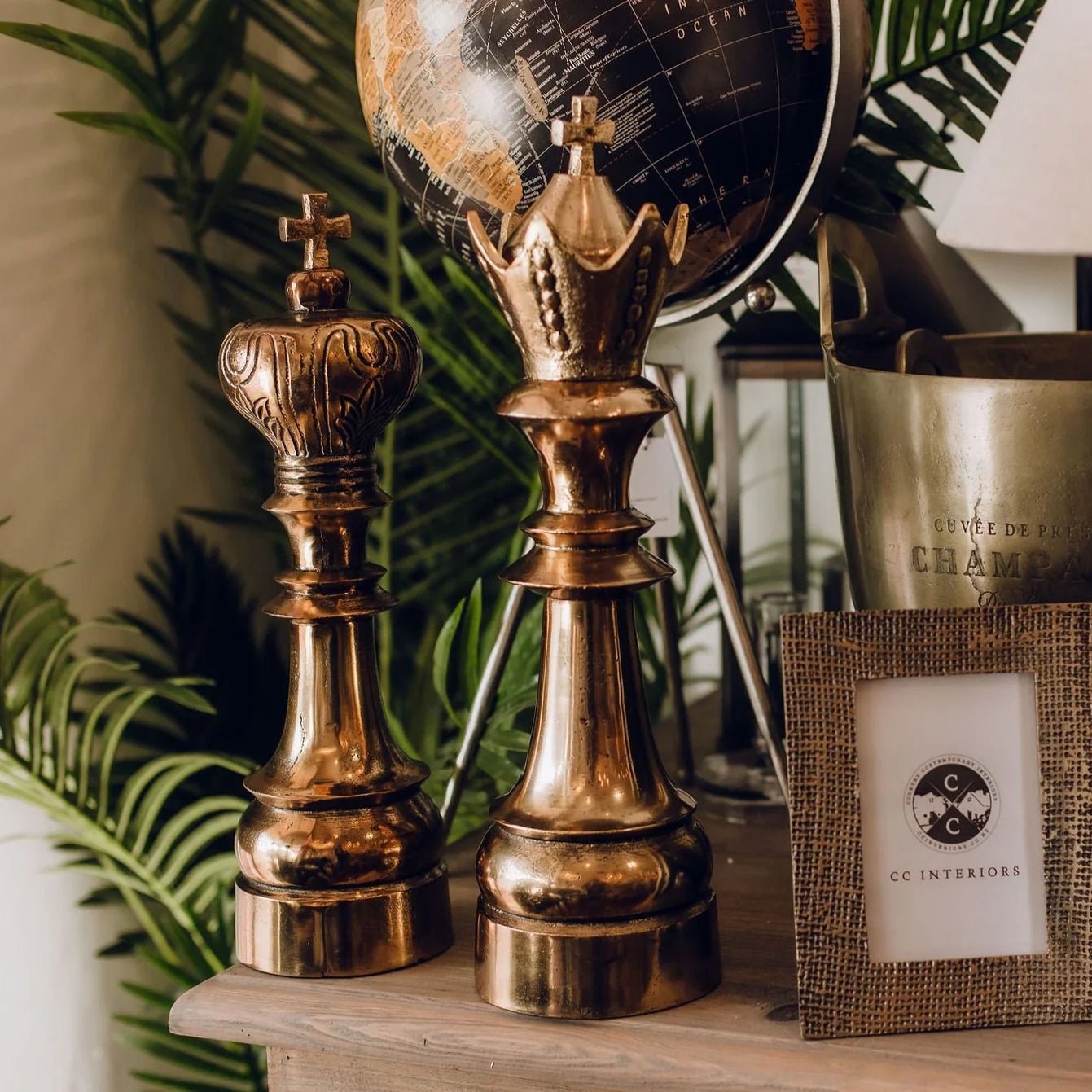 Ornamental large antique brass coloured king and queen chess pieces.