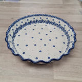 Ceramic plate with blue floral pattern on a wooden surface