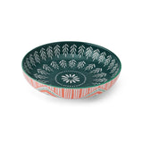 Decorative ceramic bowl with green and white pattern and red and white on a white background