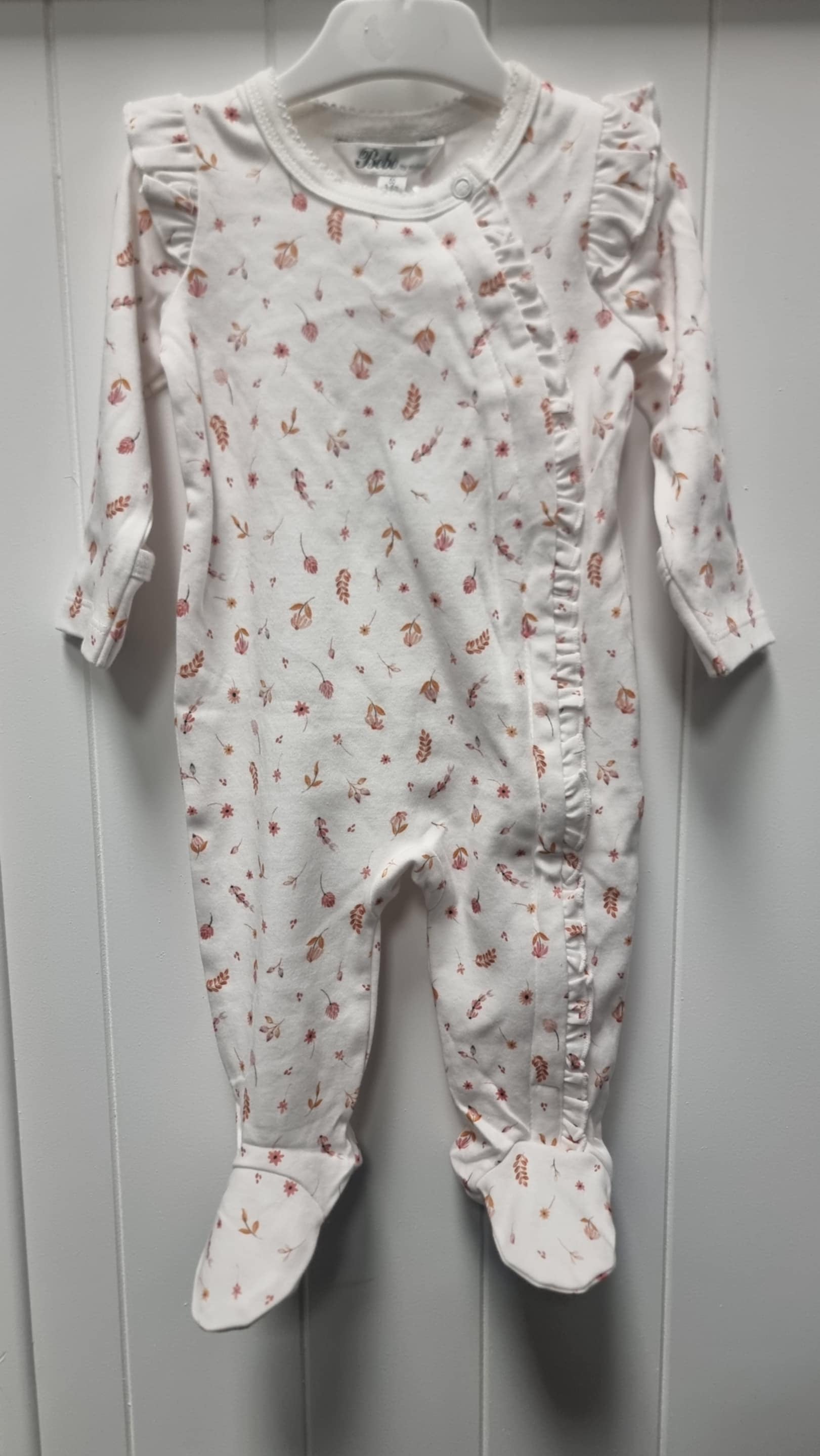 Baby onesie with floral pattern
