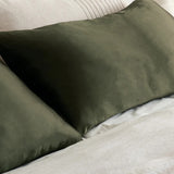 Olive green silk pillowcase on bed