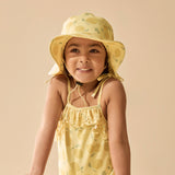 Girl wearing Yellow swim hat with lemon pattern