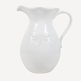 Large white ceramic jug with embossed dragonfly on the front