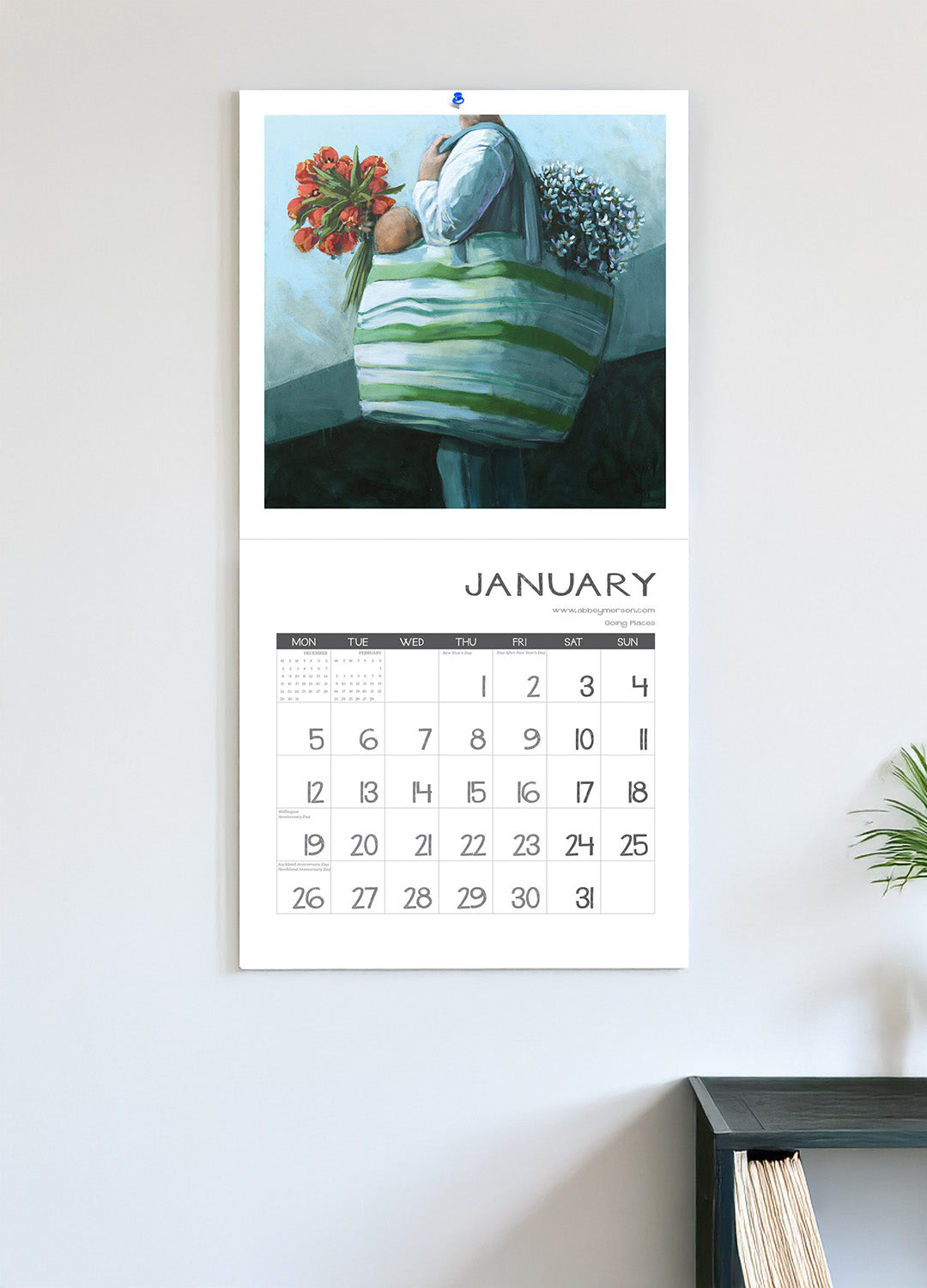 Calendar with a decorative illustration of a person holding flowers on a light gray wall.
