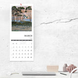 Calendar on a wall above a desk with a minimalistic design.