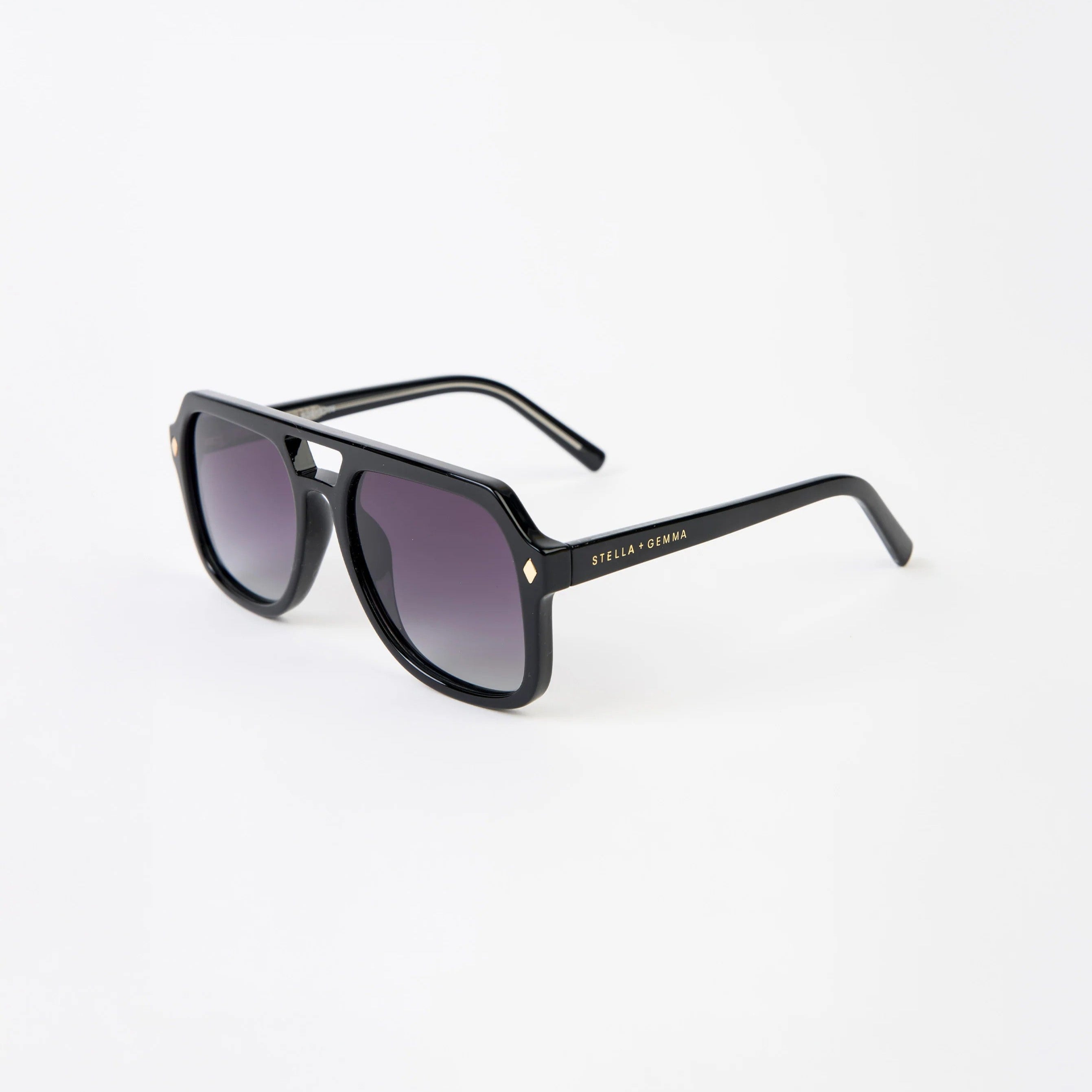 Black sunglasses with a Stella + Gemma  brand logo on a white background