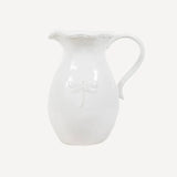 White ceramic jug with embossed dragonfly on the front