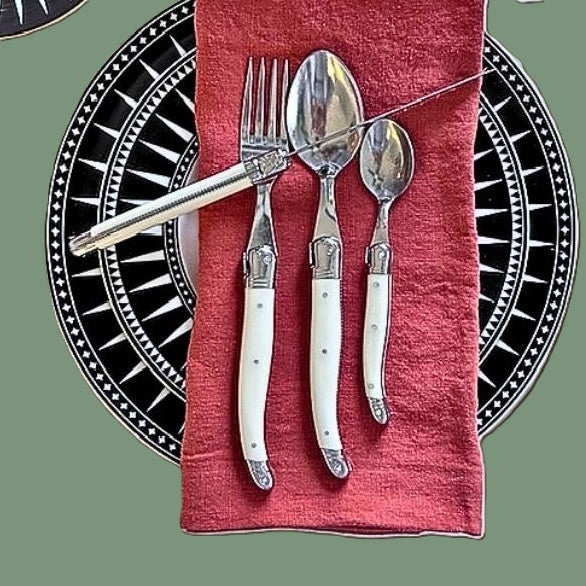 Laguiole French cutlery with the iconic bee design motif and stainless stell blades, shown here with ivory coloured handles