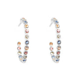 Pair of hoop earrings with multicolored gemstones on a white background