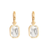 Gold earrings with clear crystals on a white background