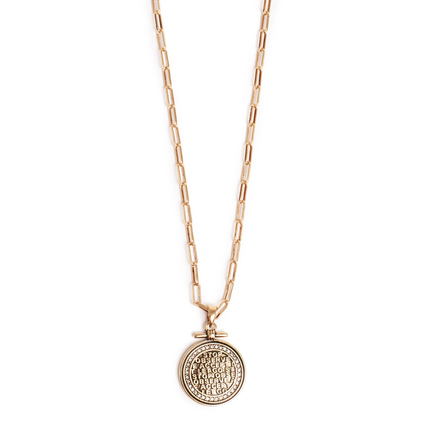 Gold necklace with a round pendant on a white background