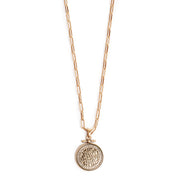 Gold necklace with a round pendant on a white background