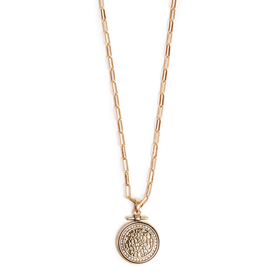 Gold necklace with a round pendant on a white background