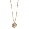 Gold necklace with a round pendant on a white background