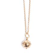 Gold necklace with a spherical pendant on a white background