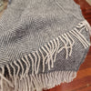 Weave Lerwick 100% wool throw in charcoal colour and tassels