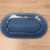 Blue oval platter with decorative edge on a wooden surface
