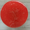 Coral coloured plate with floral design