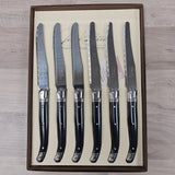 Black handled table knives with bee icon