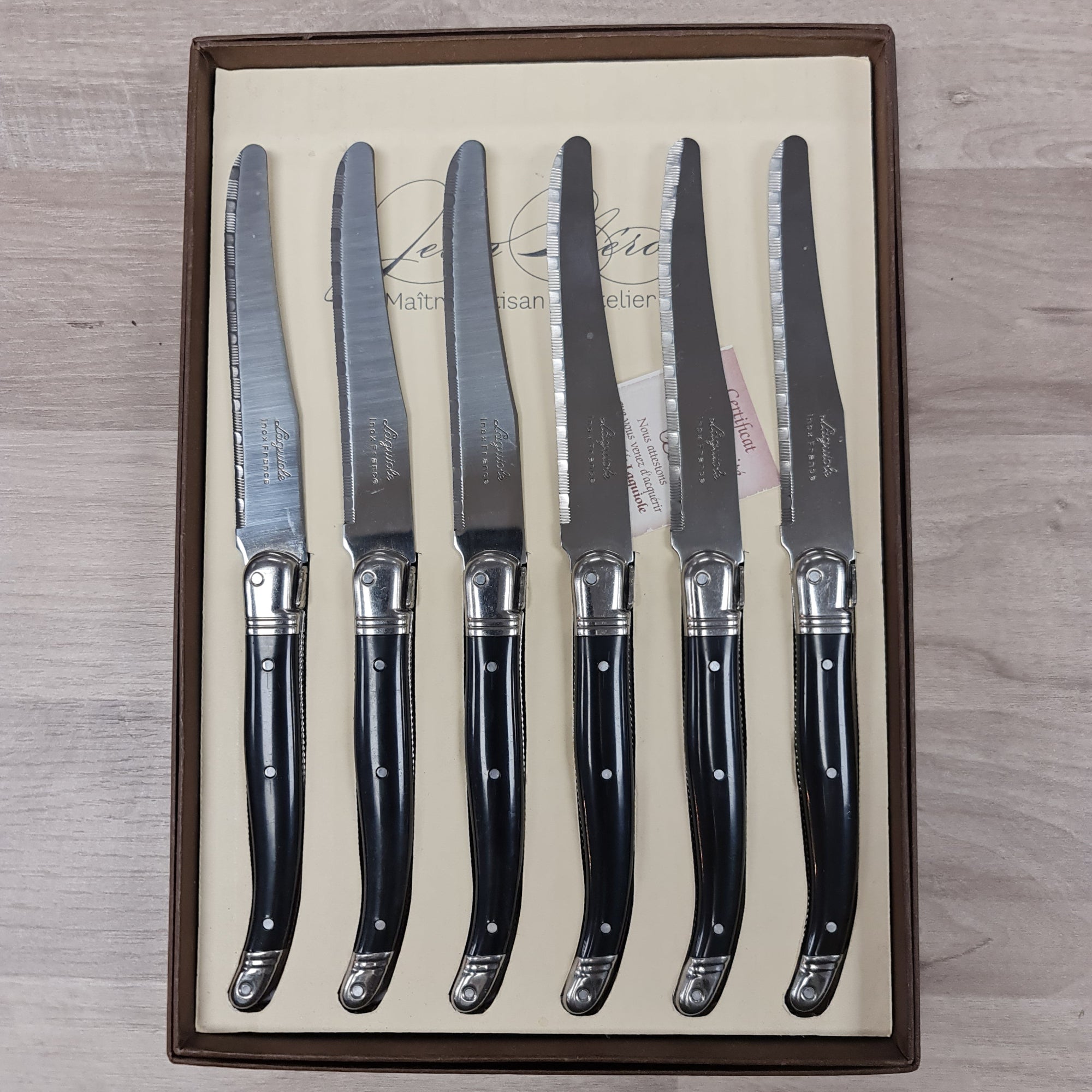 Black handled table knives with bee icon
