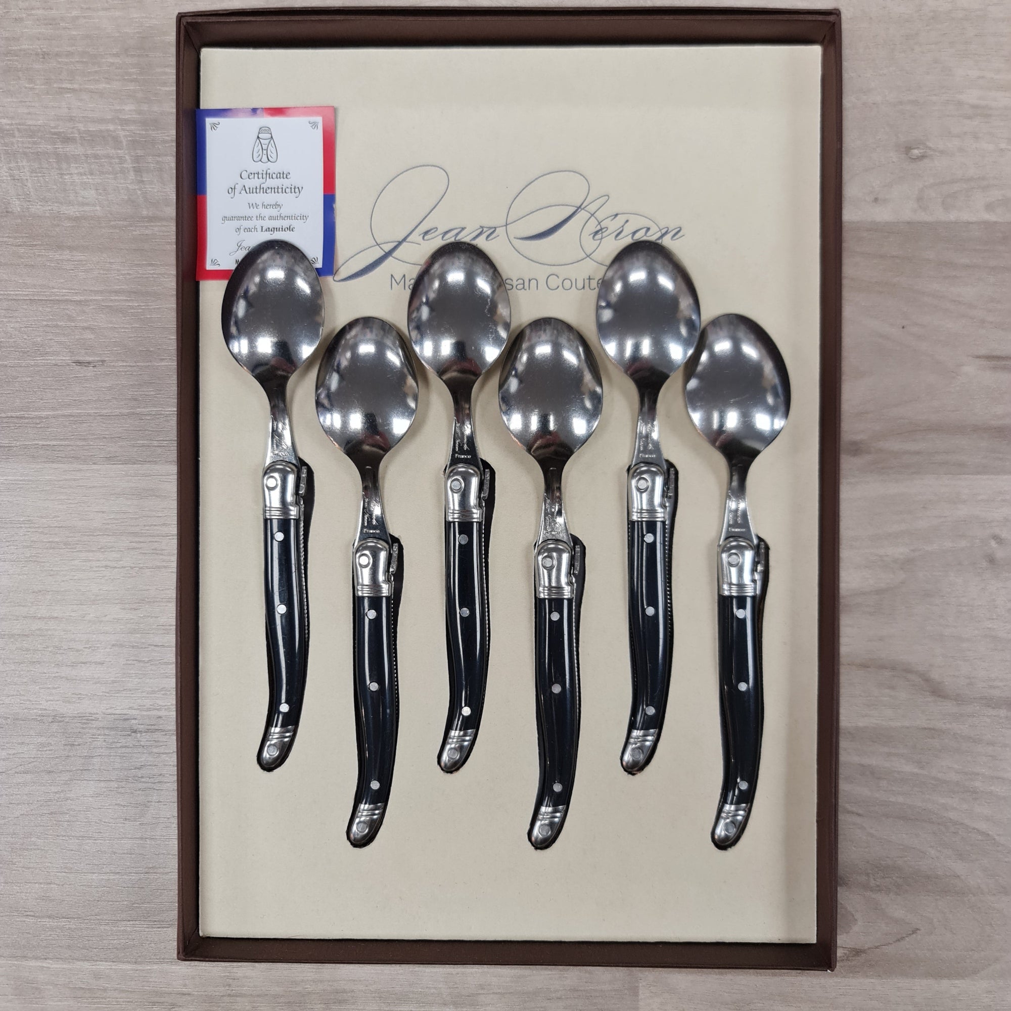 Black handled coffee spoons with bee icon
