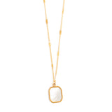 Gold necklace with a rectangular mother of pearl pendant on a white background