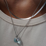Silver necklace with blue glass and crystal pendants on model