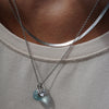 Silver necklace with blue glass and crystal pendants on model
