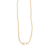 Gold necklace with a single pearl on a white background