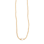 Gold necklace with a single pearl on a white background