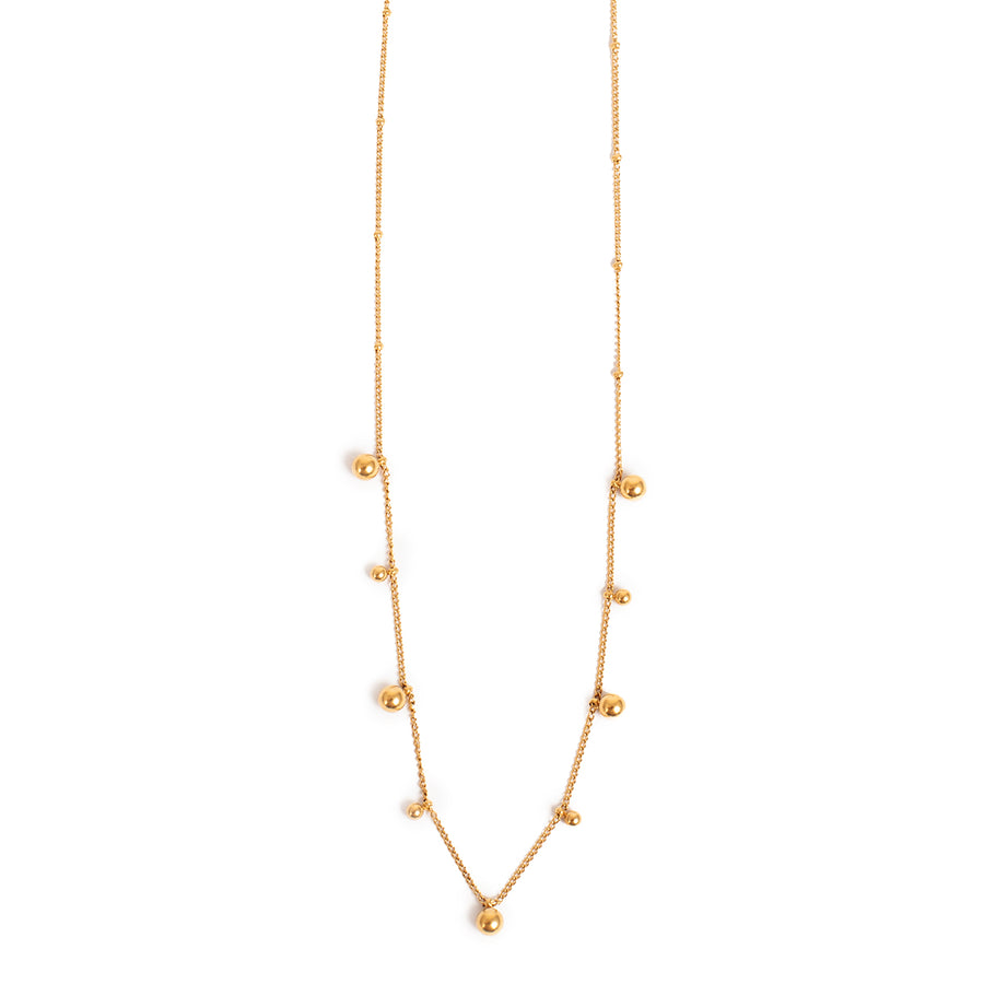 Gold necklace with small balls on a white background