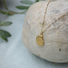 Gold shell style pendant on chain with small balls