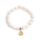 Pearl bracelet with a gold charm on a white background