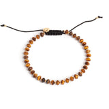 Tigereye bracelet with gold beads and black cord macrame clasp.