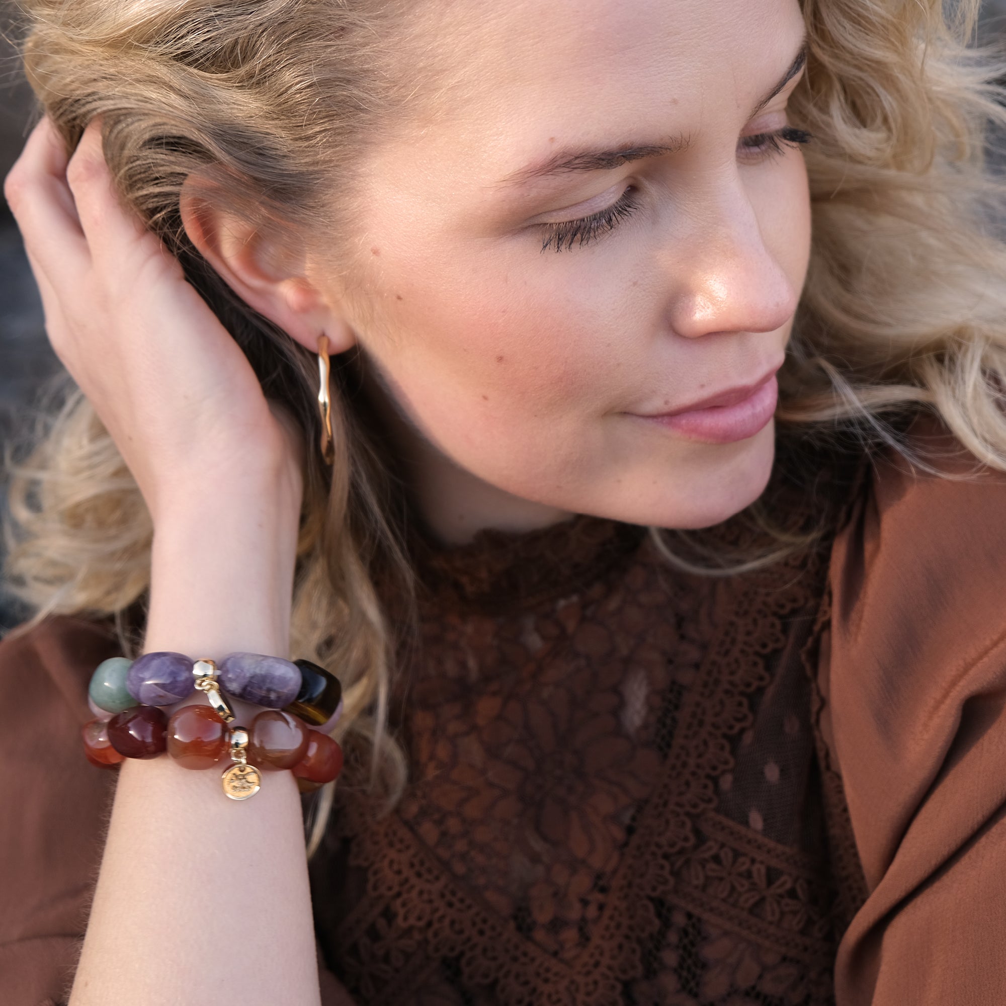 Women weraring coloured gemstone bracelets on her wrist