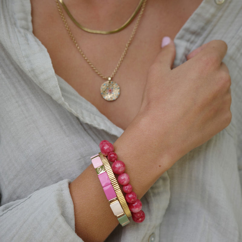 Colour ful bracelet in pink, green and natural enamel disks with gold bars.