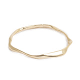 Gold irregular shaped bracelet on white background