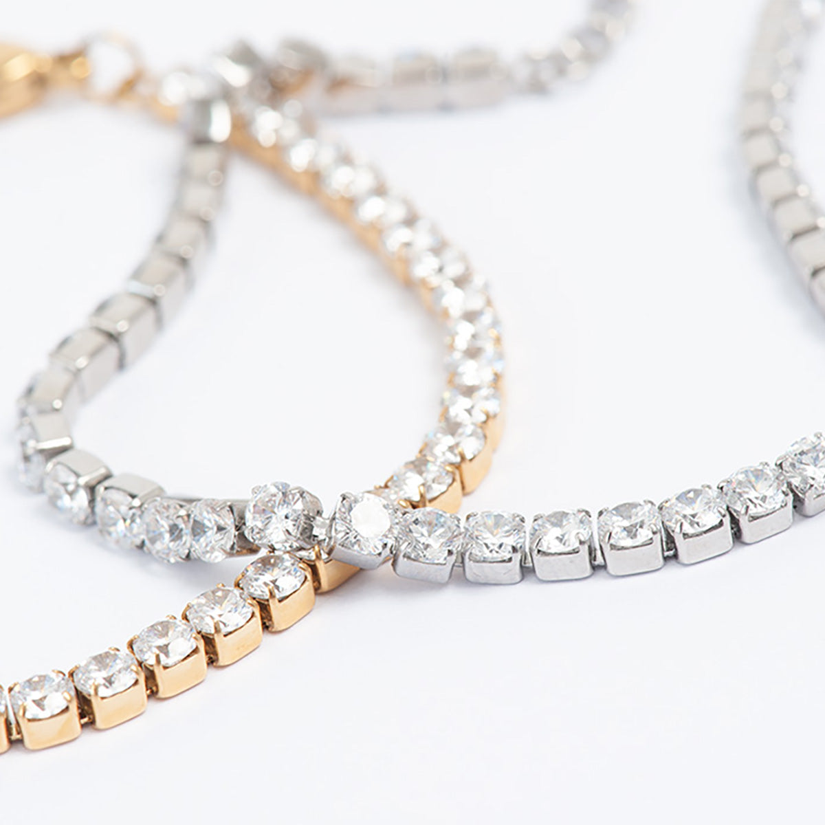 Two crystal-encrusted bracelets on a light background