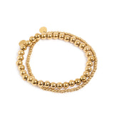 Gold beaded double layer bracelet on a white background