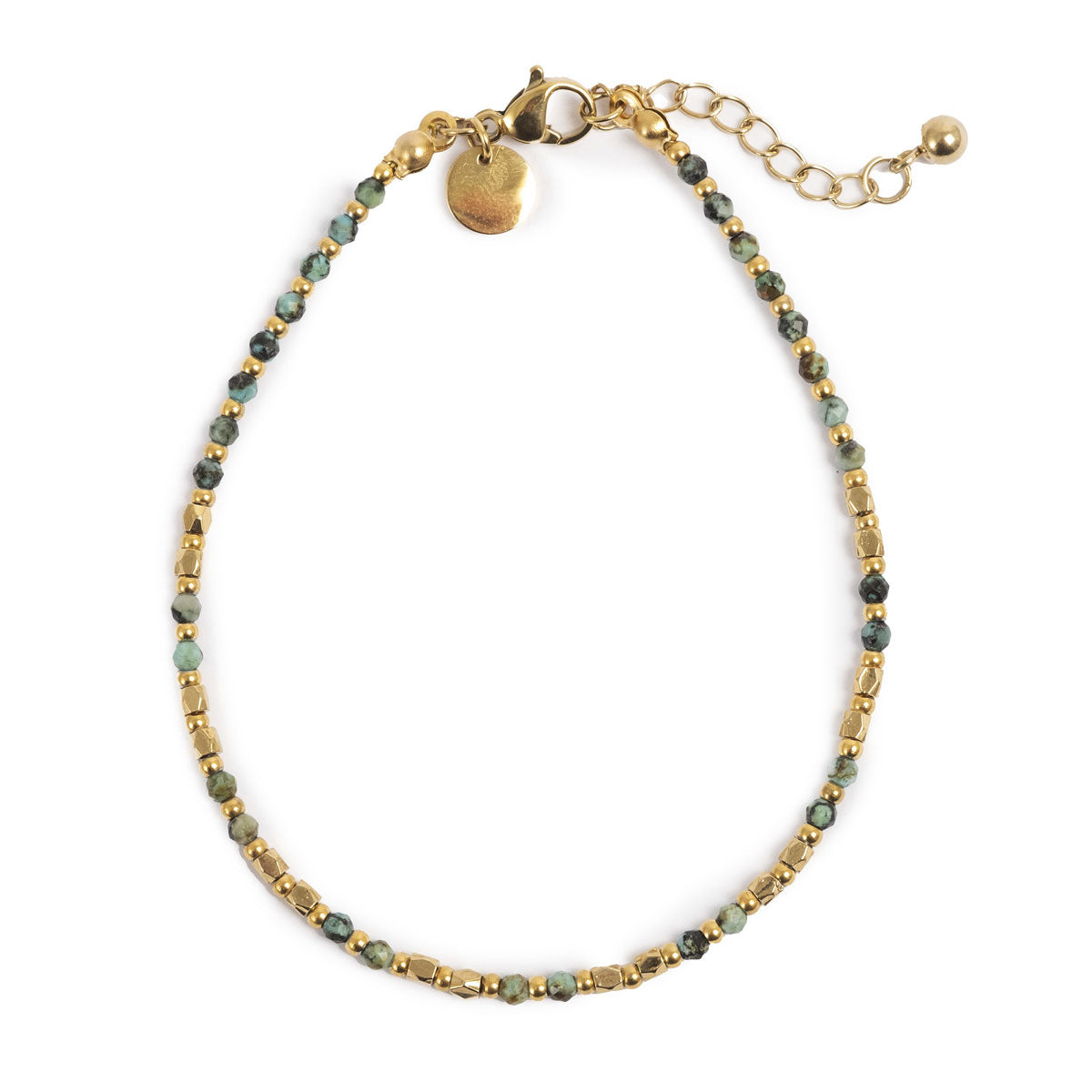 Bracelet with gold and green beads on a white background
