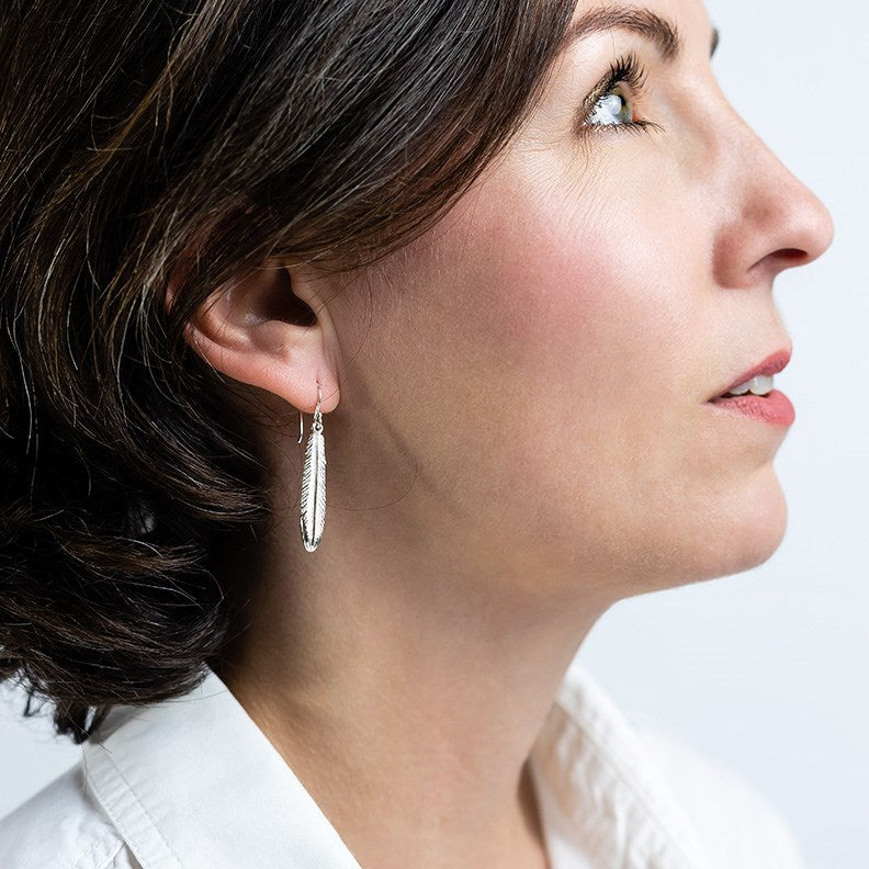 sterling silver fantail feather earrings on model