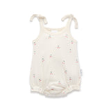 White baby romper with a cherry print and tie shoulders