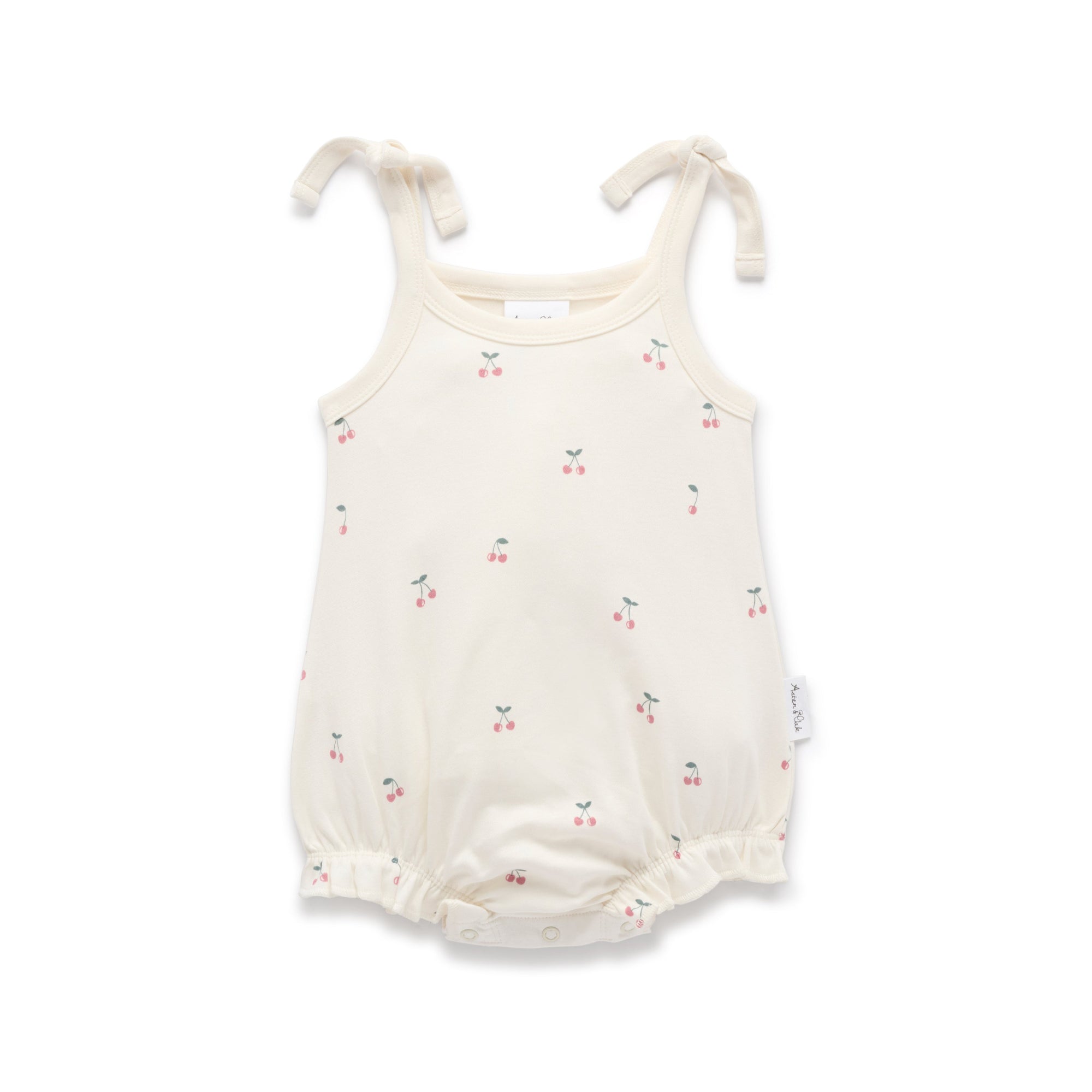 White baby romper with a cherry print and tie shoulders
