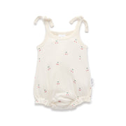 White baby romper with a cherry print and tie shoulders