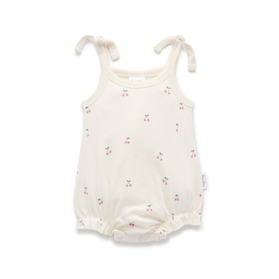 White baby romper with a cherry print and tie shoulders